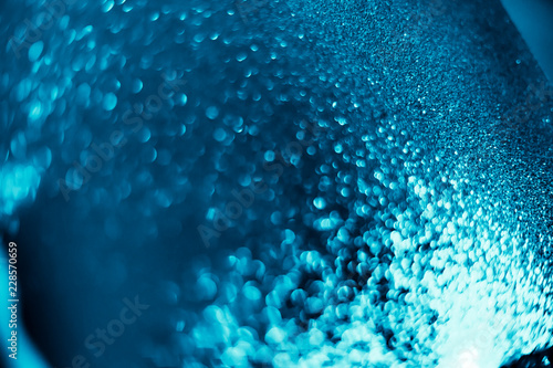 Abstract bokeh glitter background. Defocused background. Blurred bright light on black