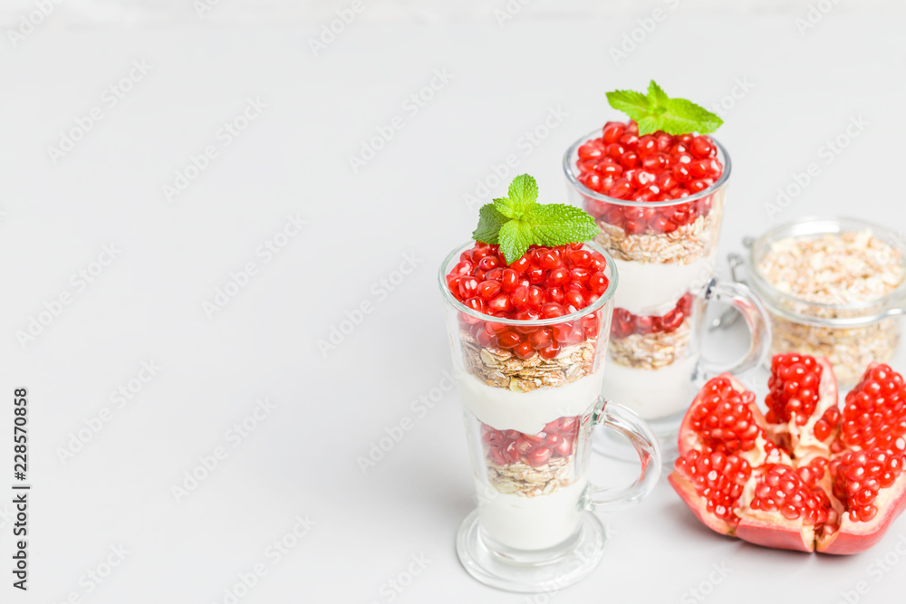 Pomegranate parfait - sweet organic layered dessert with granola flakes, yogurt and ripe fruit seeds. Pomegranate parfait - sweet organic layered dessert with granola flakes, yogurt and ripe fruit seeds.