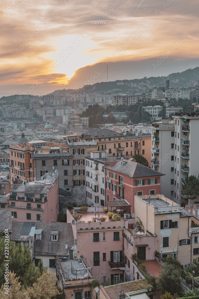 Houses on hills under sunset in Genoa, Italy