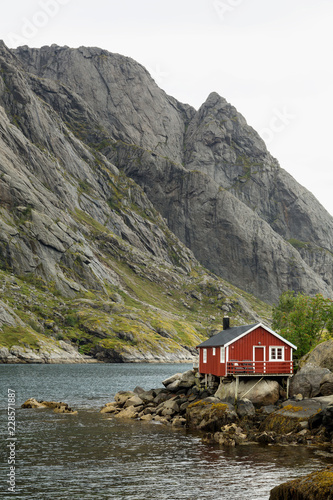 Traditional red wooden house in the small fisherman village of Nusfjord, Norway.