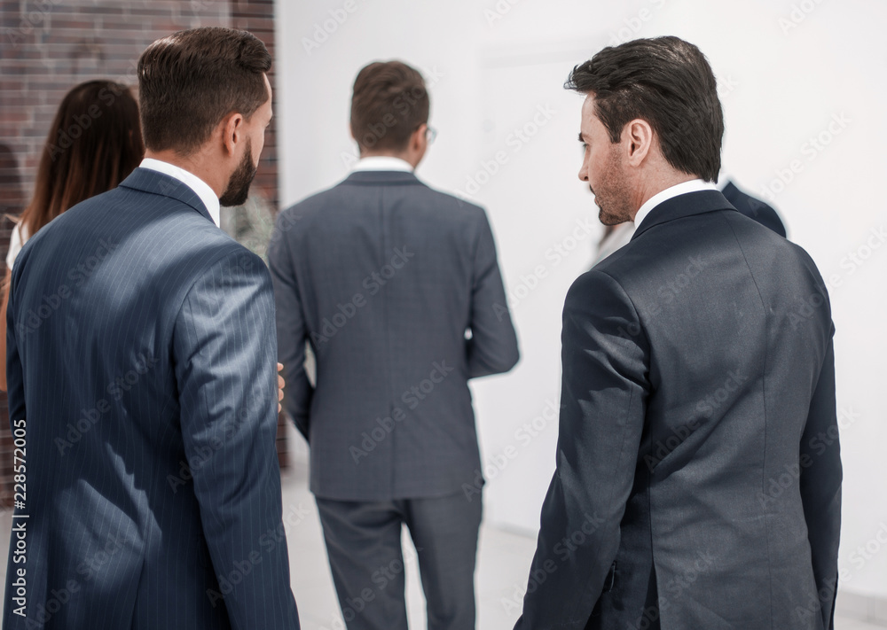 rear view.a group of business people in the business center rear view.a group of business people in the business center