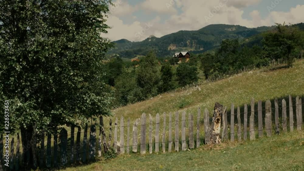 Green meadow on hill. Background of a roumanian mountain village Green meadow on hill. Background of a roumanian mountain village
