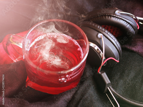 A Cup of red tea and headphones