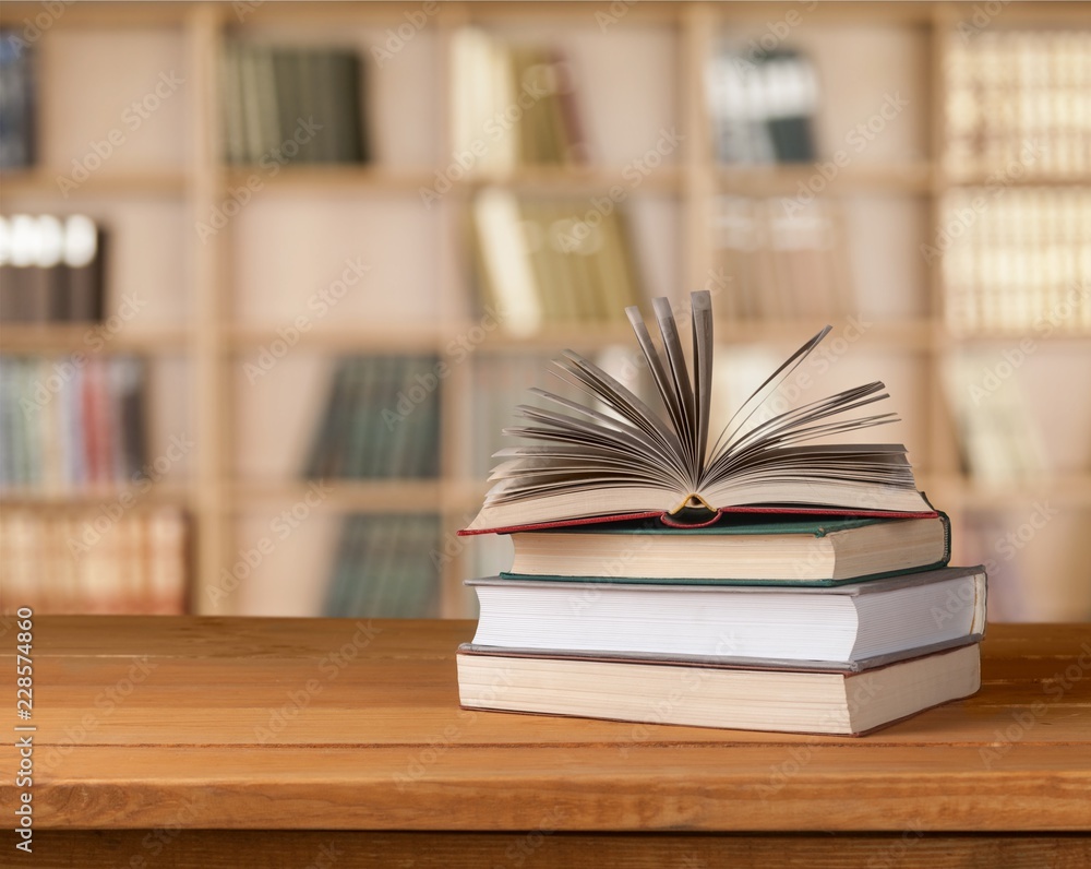 Old stacked books on wooden table