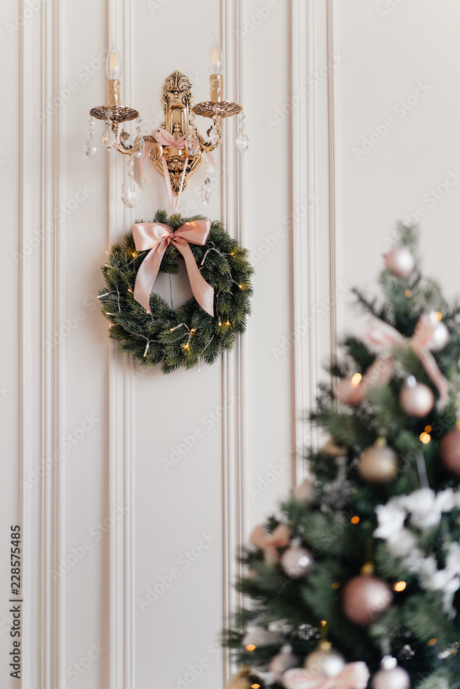 Christmas wreath on the wall next to the Christmas tree