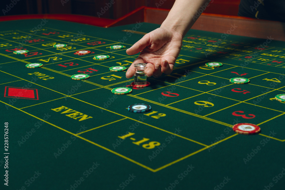 Roulette table with chips. Winning combination. Hand of Croupier with dolly. Roulette table with chips. Winning combination. Hand of Croupier with dolly.
