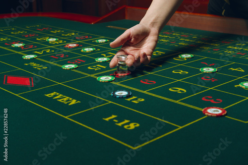 Roulette table with chips. Winning combination. Hand of Croupier with dolly.