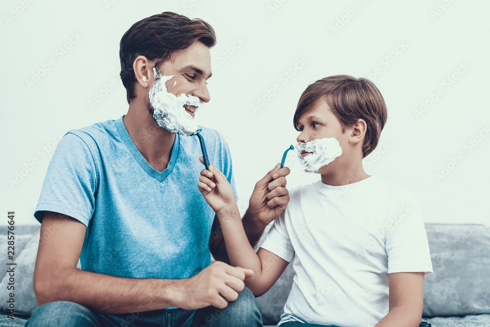 Smiling Father and Son Shaving Together at Home.