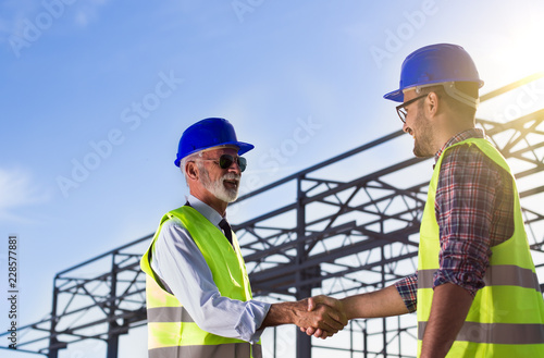 Engineers shaking hands on construction site