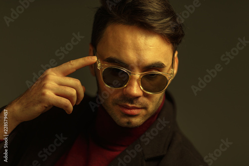 Portrait of a stylish man in sunglasses. Creative color