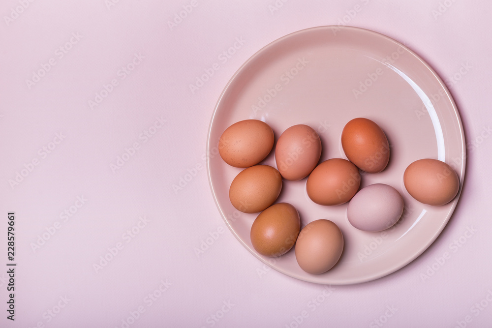 Fototapeta premium Brown chicken eggs on a plate on a table