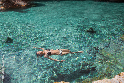 Bautiful girl relaxes in blue lagoon.