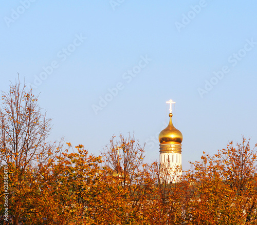 Autumn, yellow foliage, blue sky, Ivan the Great Bell Tower, church-bell tower as part of the Moscow Kremlin Cathedral Square architectural ensemble, Russia