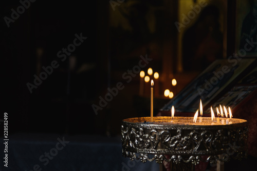flames of candles in church. Candellight in front of black background
