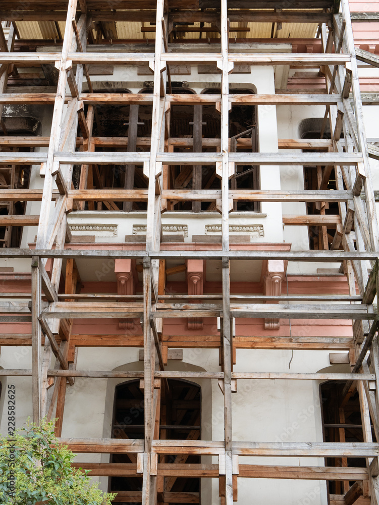 building's facade with scaffold under construction or repair restoration building's facade with scaffold under construction or repair restoration