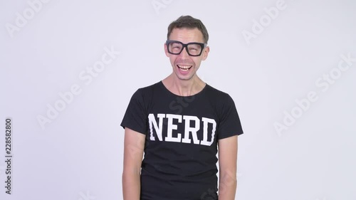 Studio shot of happy nerd man laughing and pointing to camera