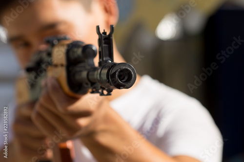Portrait of a man aiming a gun