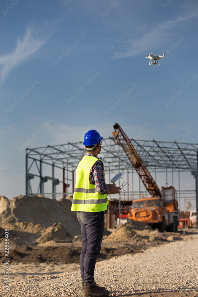 Construction worker with drone at building site Construction worker with drone at building site