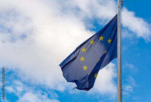 Europiean Union and Brexit, EU blue flag with yellow stars on blu sky sopy space photo