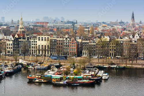 AMSTERDAM  NETHERLANDS - APRIL 10  2018  Amsterdam skyline cityscape from the Oosterdok in the Netherlands. The Oosterdok is a chanel in Amsterdam .