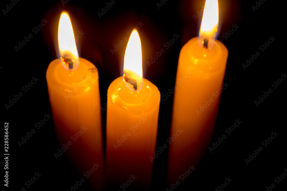 candle lit brightly against a black background candle lit brightly against a black background