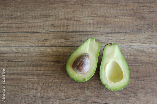 Avocados on a wooden table. Healthy food, diet. Cut avocado. copy space