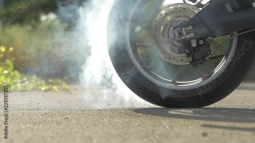 Motorbike burnout, Biker on a motorcycle drifts in smoke, burns tire on a motorcycle.