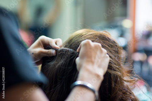 Women's haircut. hairdresser, beauty salon.soft and blur style for background.blur image of people at haircut shop.Stylist makes makeup bride on the wedding day.