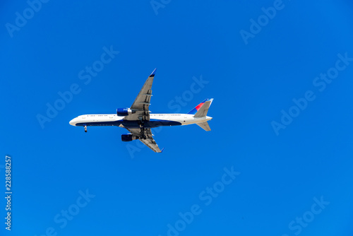 View of the plane against the blue sky, Hawaii, USA. Isolated on blue background. Copy space for text.