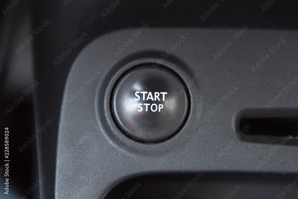 Car interior with closeup of engine start stop system button Car interior with closeup of engine start stop system button