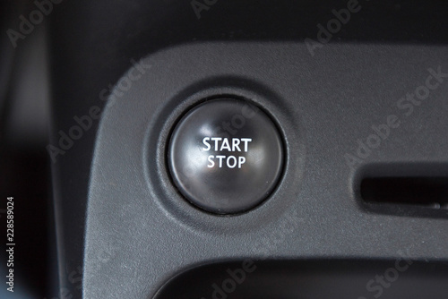 Car interior with closeup of engine start stop system button