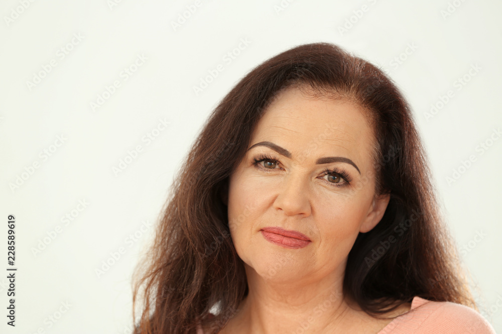 Portrait of beautiful older woman on light background Portrait of beautiful older woman on light background