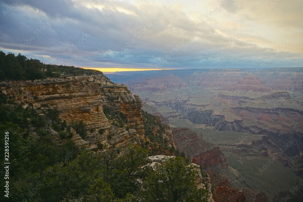 Grand Canyon National Park, Arizona, USA: Muted colors of a sunset over the Grand Canyon under a cloudy sky. Viewed from Mather Point, on the South Rim.