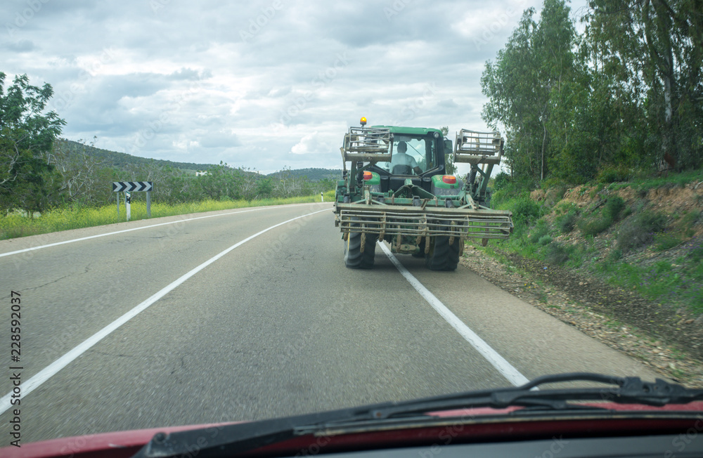 Driving slowly behind a tractor by local rural road