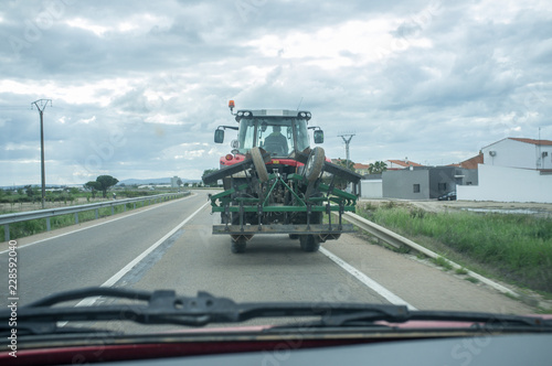 Driving slowly behind a tractor by through road