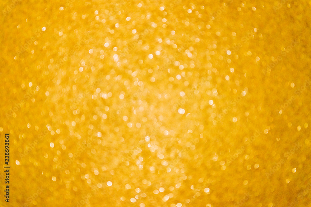 Gold glitter abstract lights background. Christmas yellow blurred bokehю Grain effect added. Gold glitter abstract lights background. Christmas yellow blurred bokehю Grain effect added.