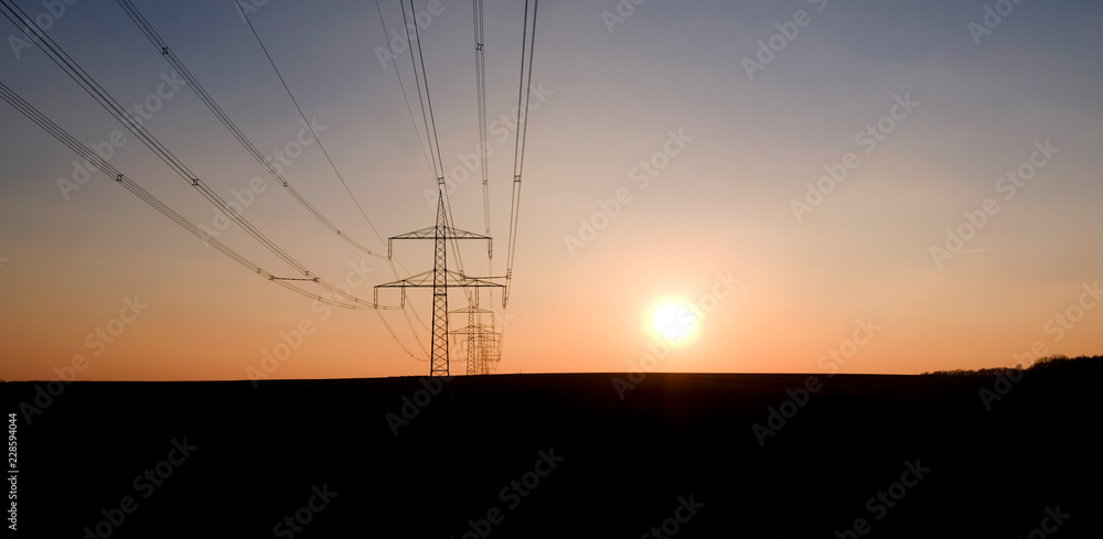 Ponitz / Germany: High voltage power line near Gruenberg in Eastern Thuringia in the deep afternoon sun