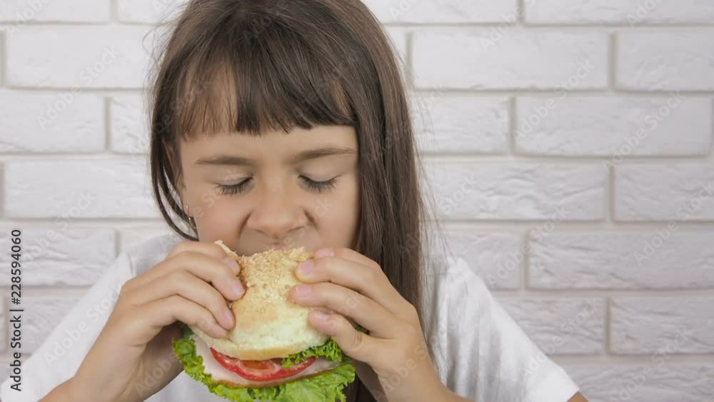 Teen girl eats a hamburger Teen girl eats a hamburger