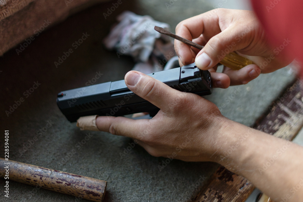 Close Up On hand Adjusting Sight on the Gun Close Up On hand Adjusting Sight on the Gun