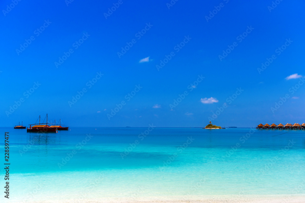View of the paradise sandy beach with Dhoni boats, Maldives. Copy space for text. View of the paradise sandy beach with Dhoni boats, Maldives. Copy space for text.