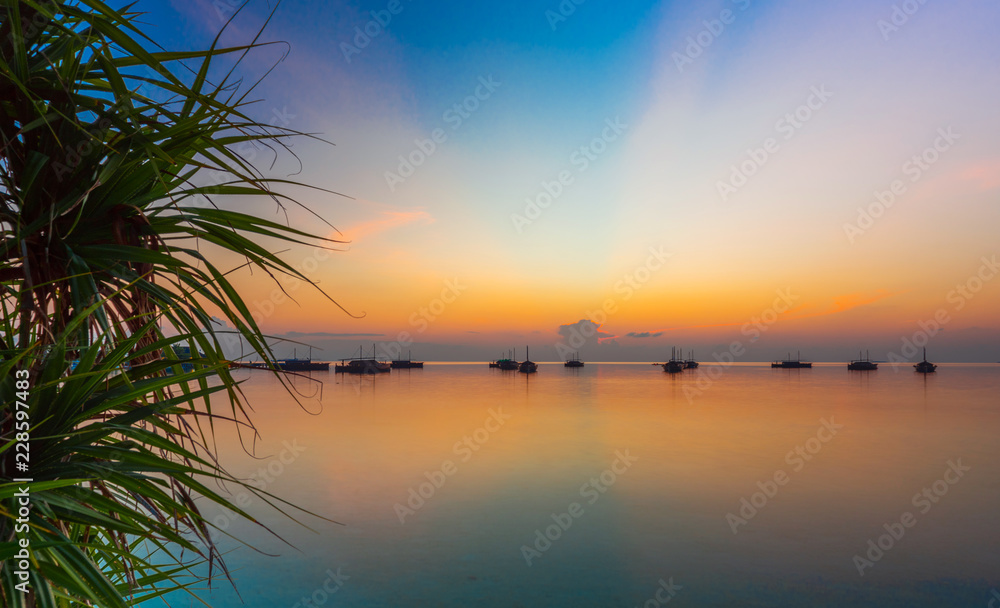 Dhoni boats on sunset background, Maldives. Copy space for text.