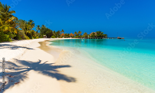 Turquoise ocean with paradise sandy beach, Maldives. Copy space for text.