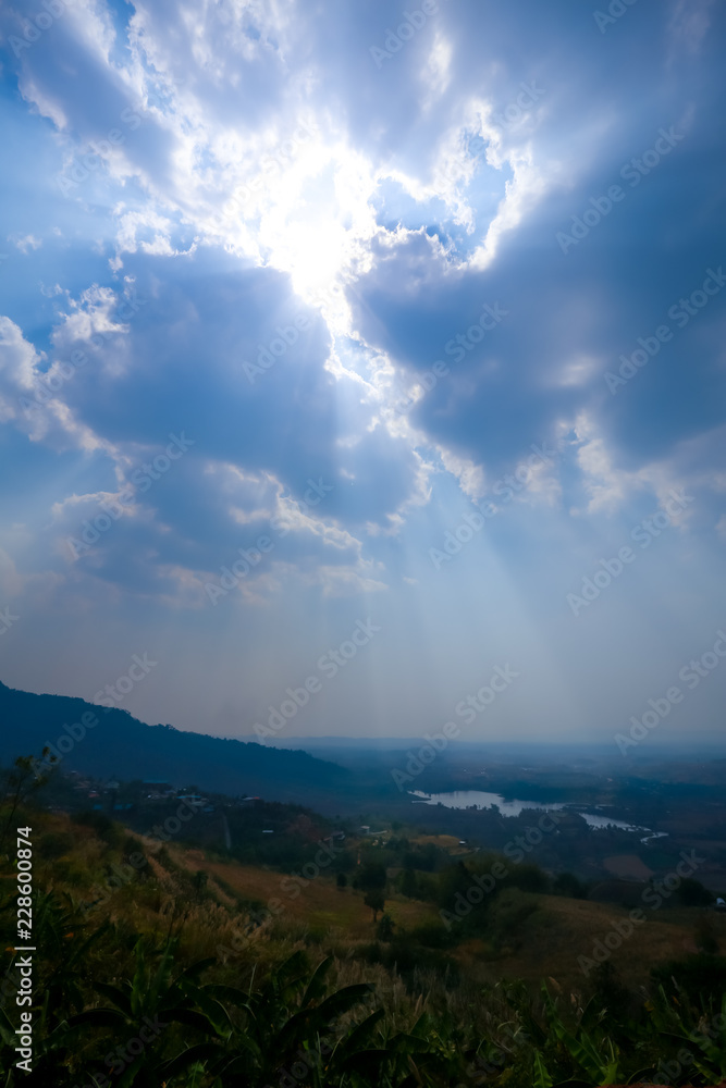 green field and blue sky with light clouds.Mountains during sun rises . Beautiful natural landscape in the northeast of Thailand 