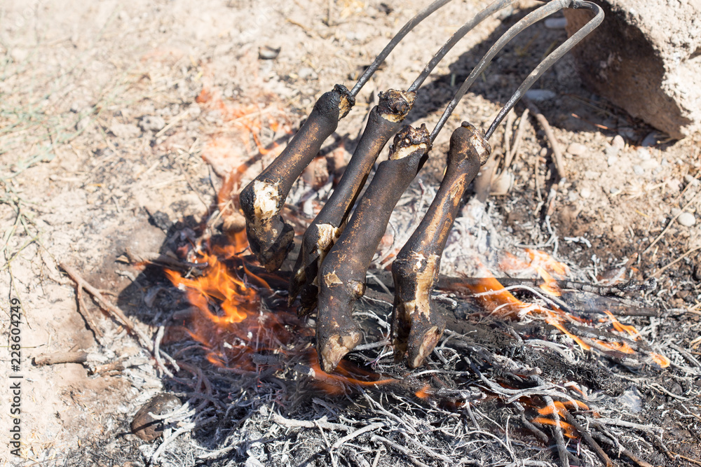 traditions of Kazakh people, slaughtered a ram and with the help of the fire removed the hair on the legs. This puts the meat on top of the national dishes beshbarmak. traditions of Kazakh people, slaughtered a ram and with the help of the fire removed the hair on the legs. This puts the meat on top of the national dishes beshbarmak.