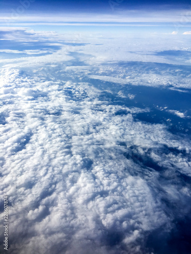 Aerial view of cloudscape from the airplane on sunny day