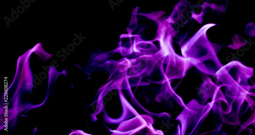 Purple fire flames on a black background photo