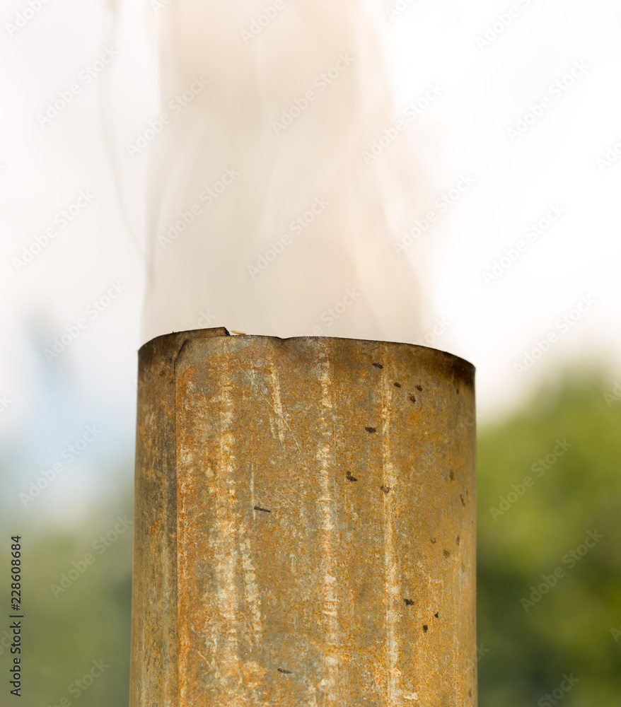 White smoke from the chimney of a samovar outdoors