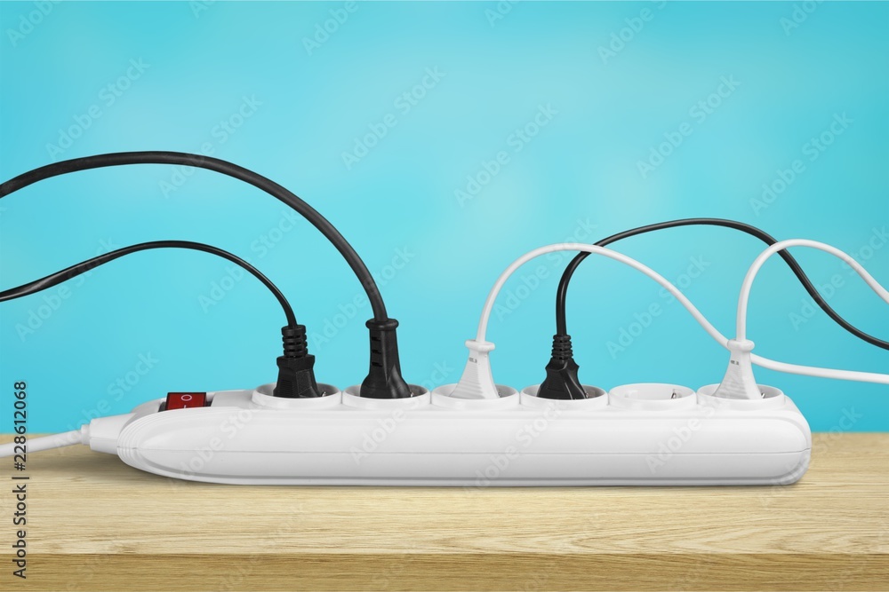 Socket strip and connected plugs on background Socket strip and connected plugs on background