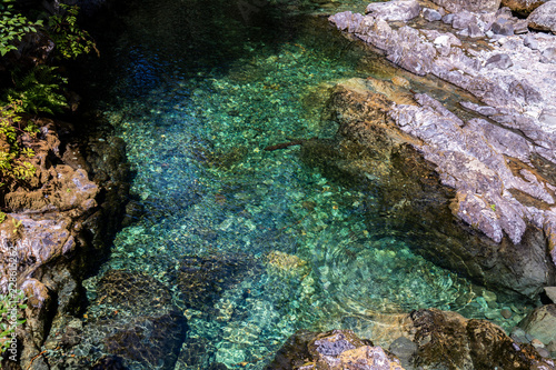 Crystal clear emerald water of Opal Creek, Oregon with rock and ripple