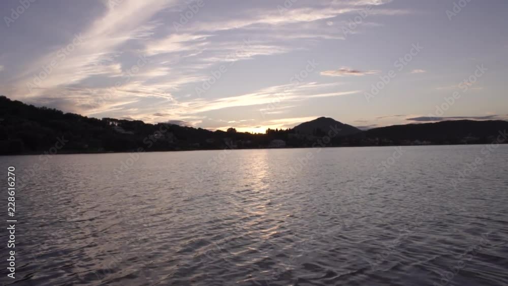 Warm sunset clouds over gentle sea landscape in Corfu Greece Warm sunset clouds over gentle sea landscape in Corfu Greece